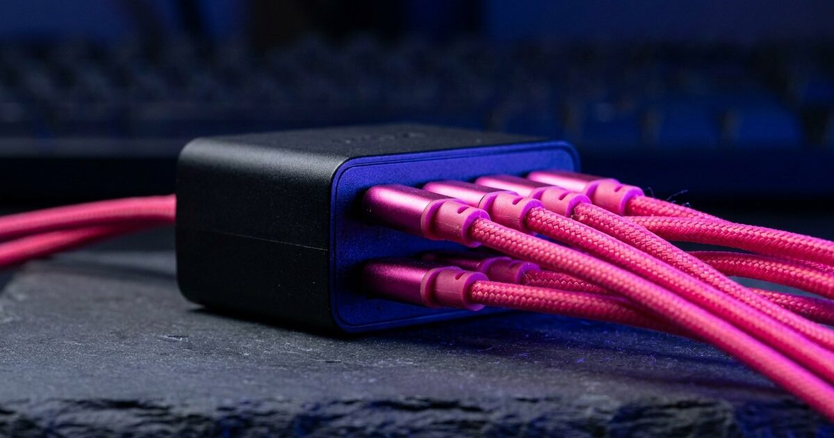Seven thick pink cables crammed into one small module's single face, splayed at strained angles and crowding each other