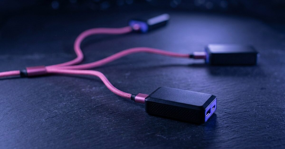 A single pink cable forks into three long branches reaching modules at three different distances across dark slate